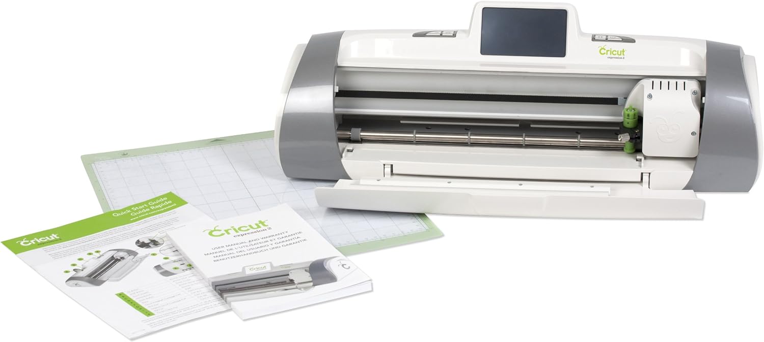 Cricut machine with cutting mat and instructional guides.